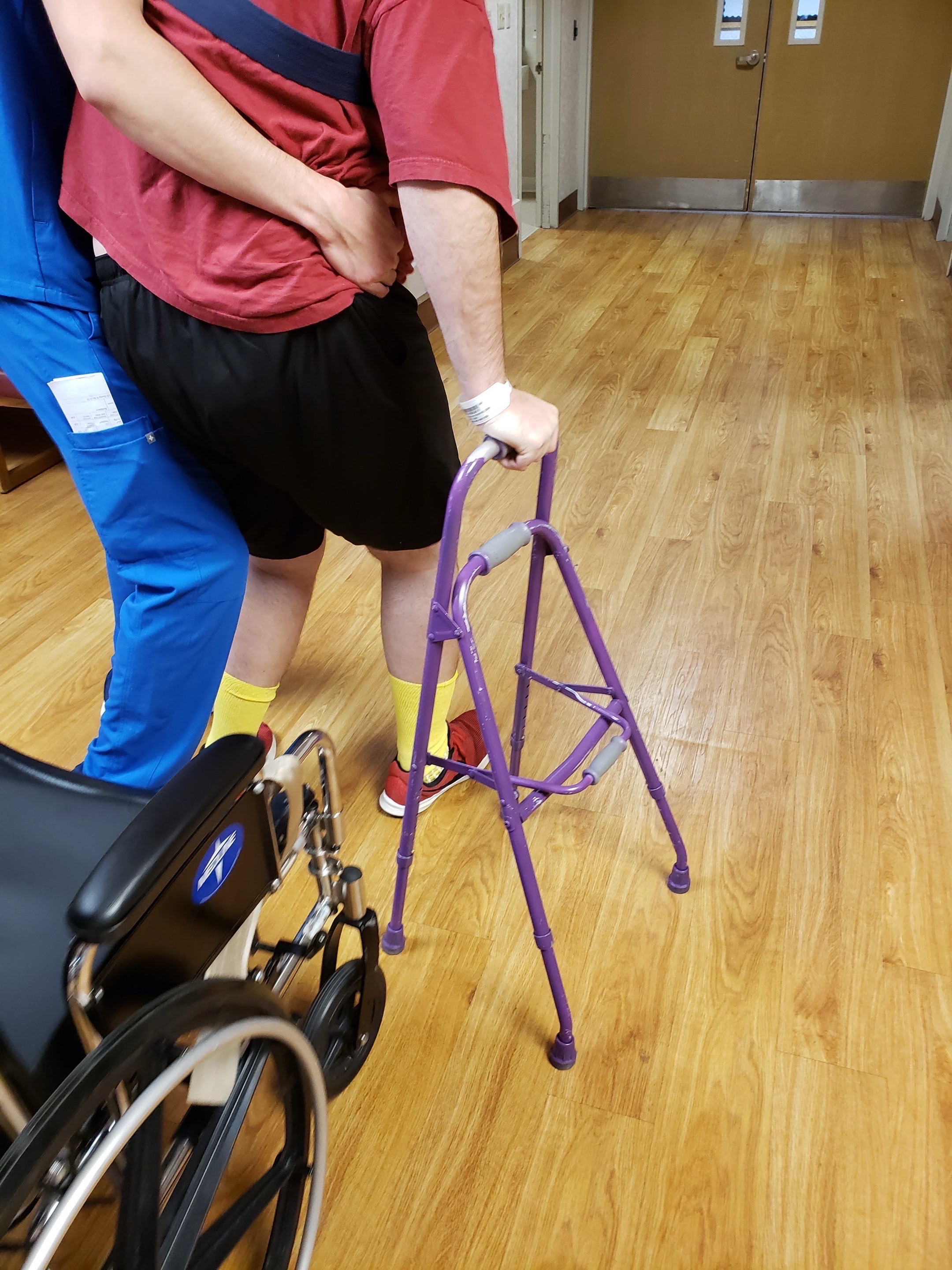 Nick in physical therapy during stroke recovery, walking with walker support